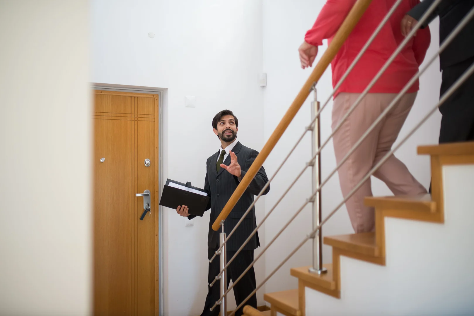 Buyer and estate agent discussing property options in an office Buyer and estate agent discussing property options in an office